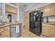 Modern kitchen with granite counters, stainless steel appliances, and natural wood cabinets at 5430 Baytowne Pl, Oviedo, FL 32765