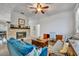Bright living room with stone fireplace, wood floors, and an open view to a study space at 5430 Baytowne Pl, Oviedo, FL 32765
