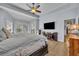 Large main bedroom with tray ceiling, ceiling fan, and sliding glass doors to the lanai at 5430 Baytowne Pl, Oviedo, FL 32765