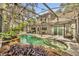 The outdoor pool area includes mature landscaping, dining, covered area, and easy access to the home at 5430 Baytowne Pl, Oviedo, FL 32765