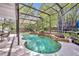 Screened in pool with a small waterfall, landscaping and patio furniture at 5430 Baytowne Pl, Oviedo, FL 32765