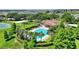 Aerial view of the community pool and recreational facilities nestled amongst lush greenery and landscaping at 546 Windsor Pl, Davenport, FL 33896