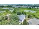 Aerial view of home and surrounding area, with lush trees and landscaping at 546 Windsor Pl, Davenport, FL 33896