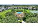 Aerial view of the community clubhouse, pool, and surrounding neighborhood at 546 Windsor Pl, Davenport, FL 33896