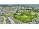 Wide angle aerial shot of a suburban neighborhood with homes backing to a large natural conservation area at 546 Windsor Pl, Davenport, FL 33896