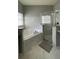 Bathroom featuring a tub and frameless glass shower with modern fixtures and marble tile at 546 Windsor Pl, Davenport, FL 33896