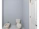 This bathroom features a toilet, bidet, and white door at 546 Windsor Pl, Davenport, FL 33896