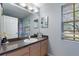 Bathroom featuring a granite counter and an ample amount of vanity storage at 546 Windsor Pl, Davenport, FL 33896