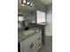 Bright bathroom with white cabinets, granite countertops, tub, and glass shower enclosure at 546 Windsor Pl, Davenport, FL 33896