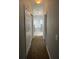 Hallway view of the bathroom showcases a tub, shower, and tiled wall at 546 Windsor Pl, Davenport, FL 33896