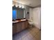 This bathroom features double sinks, tile floors, and shower-tub combo at 546 Windsor Pl, Davenport, FL 33896