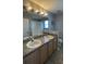 Bathroom featuring double sink vanity, tile flooring, and shower at 546 Windsor Pl, Davenport, FL 33896