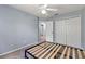 Comfortable bedroom with spacious closet and doorway providing access to a bathroom at 546 Windsor Pl, Davenport, FL 33896