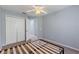 Cozy bedroom with a ceiling fan and access to a closet and doorway at 546 Windsor Pl, Davenport, FL 33896