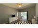 Bright bedroom with sliding doors leading to the pool, ceiling fan and a dresser at 546 Windsor Pl, Davenport, FL 33896