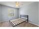 This bedroom has a ceiling fan and window letting in natural light at 546 Windsor Pl, Davenport, FL 33896