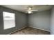 Bedroom with neutral walls, carpet flooring, and natural light from a window at 546 Windsor Pl, Davenport, FL 33896