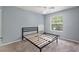 This bedroom has neutral paint, plush carpeting, and a window for natural light at 546 Windsor Pl, Davenport, FL 33896
