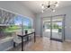 Dining area with modern light fixture and view of the pool area at 546 Windsor Pl, Davenport, FL 33896