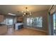 Dining room features a modern light fixture and sliding door access to a patio at 546 Windsor Pl, Davenport, FL 33896