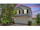 Two story home with well-manicured landscaping, attached garage and neutral paint at 546 Windsor Pl, Davenport, FL 33896