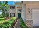 Attractive home with a beautiful lawn, colorful shrubbery, and a stately front door and entryway at 546 Windsor Pl, Davenport, FL 33896