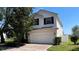 Charming two-story home with a brick driveway and well-manicured lawn at 546 Windsor Pl, Davenport, FL 33896