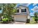 Inviting two-story home featuring manicured landscaping and a paved driveway at 546 Windsor Pl, Davenport, FL 33896