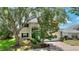 Charming two-story home with lush landscaping, a brick driveway, and a welcoming facade at 546 Windsor Pl, Davenport, FL 33896
