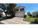 Charming two-story home with brick driveway, attached garage, and well-maintained landscaping at 546 Windsor Pl, Davenport, FL 33896