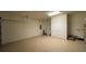 A large garage space with epoxy flooring and additional storage or workspace at 546 Windsor Pl, Davenport, FL 33896