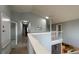 Upstairs hallway with views of the kitchen and access to rooms with carpet flooring at 546 Windsor Pl, Davenport, FL 33896