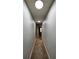 The hallway has neutral colored walls and carpet floors throughout at 546 Windsor Pl, Davenport, FL 33896