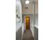 Hallway with natural lighting and neutral colored paint throughout at 546 Windsor Pl, Davenport, FL 33896