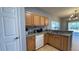 Galley kitchen with stainless appliances and wooden cabinets at 546 Windsor Pl, Davenport, FL 33896