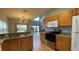 Kitchen features wooden cabinets and opens to the living room at 546 Windsor Pl, Davenport, FL 33896