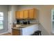 Cozy kitchen with wooden cabinets, neutral countertops and stainless steel sink at 546 Windsor Pl, Davenport, FL 33896
