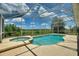 Beautiful screened-in pool and spa with stunning backyard views and ample deck space at 546 Windsor Pl, Davenport, FL 33896
