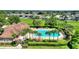 Relax and enjoy the sun at this community pool, surrounded by palm trees, lush landscaping, and lounge chairs at 546 Windsor Pl, Davenport, FL 33896