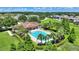 A relaxing community pool is surrounded by palm trees, lush landscaping, and plenty of lounge chairs at 546 Windsor Pl, Davenport, FL 33896