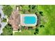 An aerial view shows the community pool lined with lounge chairs with an adjacent clubhouse at 546 Windsor Pl, Davenport, FL 33896