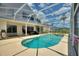Gorgeous screened-in pool and spa with scenic views and easy access to the home's interior at 546 Windsor Pl, Davenport, FL 33896
