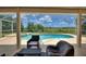 Inviting screened-in pool and spa area with lush landscaping and outdoor seating at 546 Windsor Pl, Davenport, FL 33896