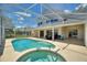 Large screened-in pool with spa, patio and outside seating at 546 Windsor Pl, Davenport, FL 33896