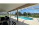 Enclosed patio featuring a sparkling pool with a spa and seating area at 546 Windsor Pl, Davenport, FL 33896