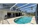 Spacious screened-in pool area with ample lounge seating and mature landscaping at 546 Windsor Pl, Davenport, FL 33896