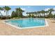 Community swimming pool surrounded by lush landscaping and lounge chairs at 546 Windsor Pl, Davenport, FL 33896
