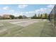 Community tennis court surrounded by a tall fence, perfect for recreational games at 546 Windsor Pl, Davenport, FL 33896