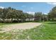 Sandy volleyball court with green grassy surroundings, perfect for outdoor activities at 546 Windsor Pl, Davenport, FL 33896