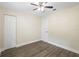 Bedroom with light-colored walls, wood floors, a ceiling fan and standard closet at 5815 Holmes Dr, Orlando, FL 32808